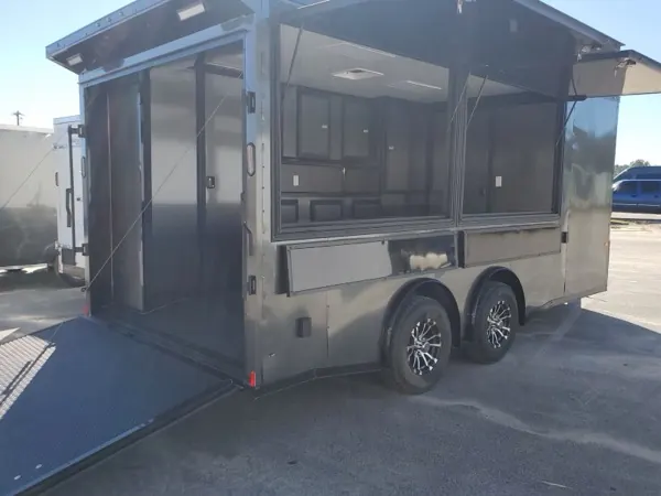 Charcoal concession trailer with serving windows open and the rear ramp down