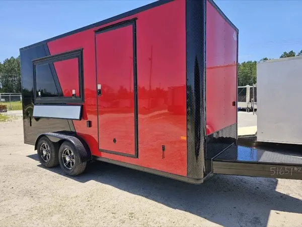 Red and black concession trailer with the serving window propped open and a rear deck