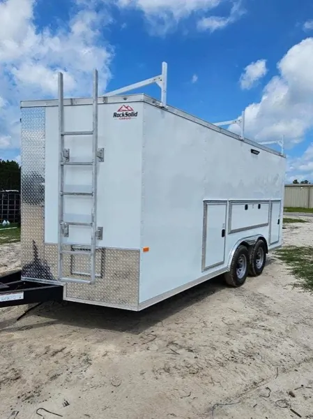 White contractor trailer with a mounted side ladder, roof rack, and side compartment doors