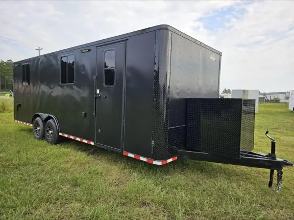 Charcoal tandem axle cargo trailer with a generator box on the tongue
