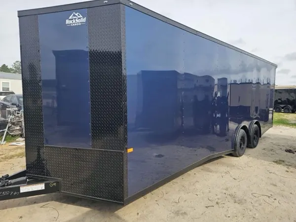 Navy blue tandem axle cargo trailer with black trim and a diamond plate front, side view