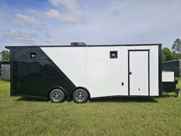 White and black two-tone tandem axle cargo trailer, side view